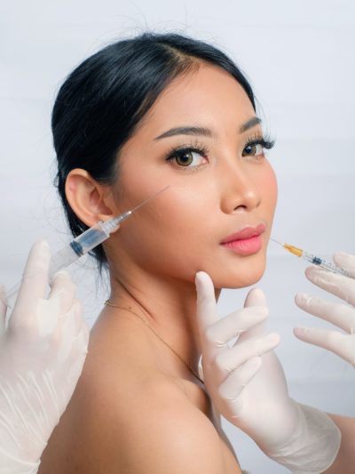 Close-up of a professional administering a dermal filler dissolving treatment to safely remove unwanted filler and restore natural facial contours.